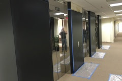 Custom wall panel built for lobby renovation in the Raleigh-Durham area. This in-process photo shows the reveals painted black and the blank panels installed.