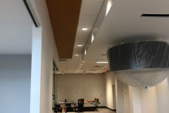 Ceiling and soffit wrap for a Jeep dealership using a custom 3M DiNoc woodgrain pattern.